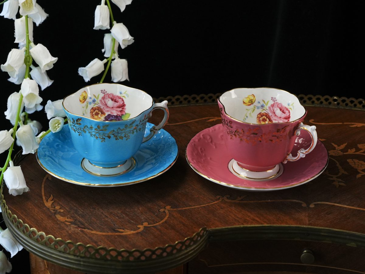 Aynsley panelled quad-lobed square shape teacup pair in turquoise and coral with hand painted cottage bouquet interiors