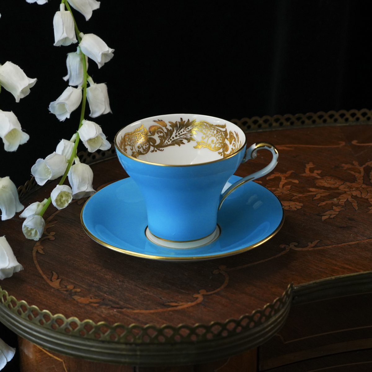 Aynsley turquoise corset shape teacup and saucer with acid-etched gold acanthus interior