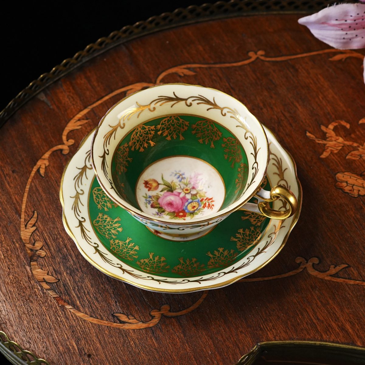 Vintage Foley (E. Brain & Co.) bone china teacup and saucer with an emerald green band, gold filigree fern sprays and a hand-coloured rose and tulip bouquet