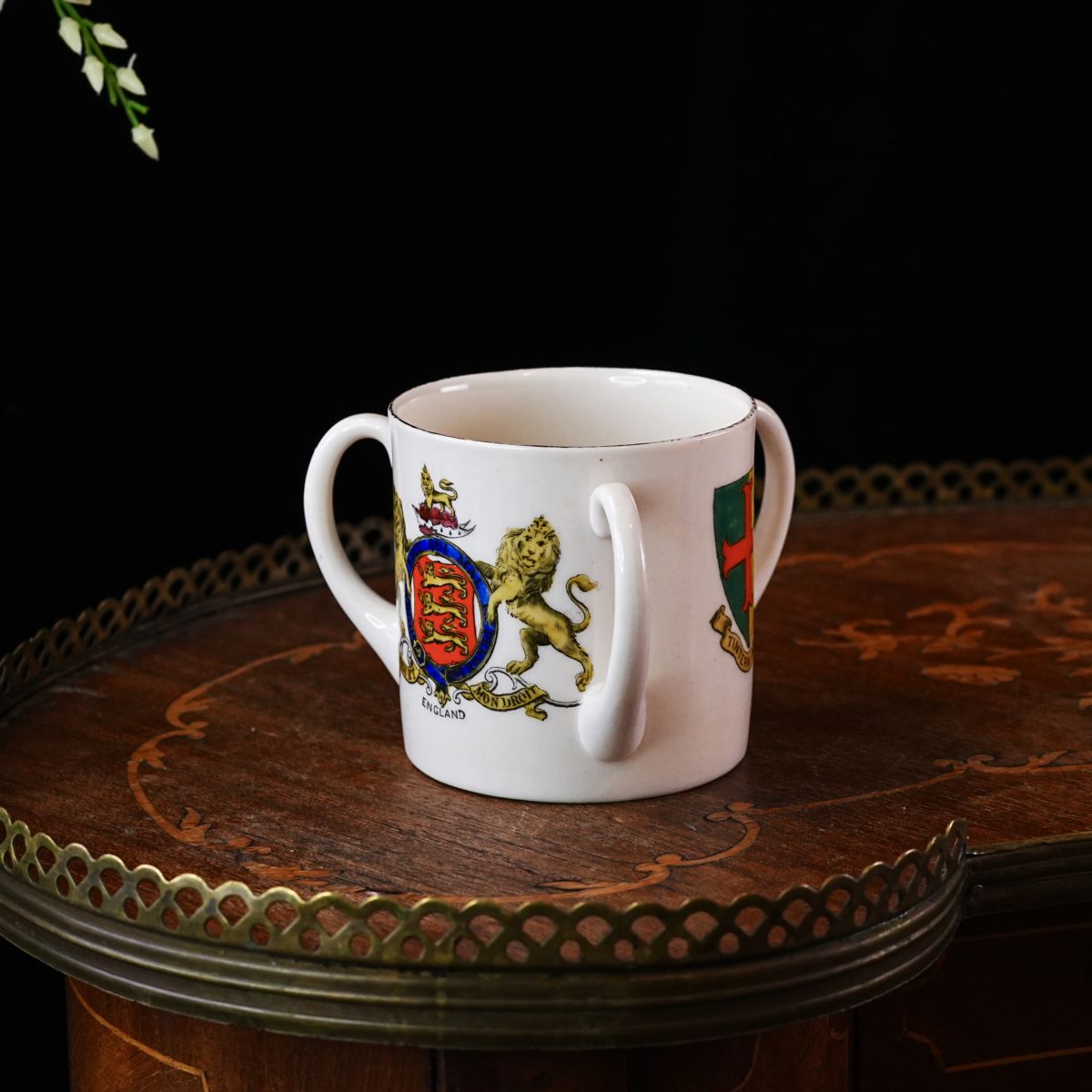 W.H. Goss three-handled loving cup with royal crests and Tintern Abbey arms, white crested china